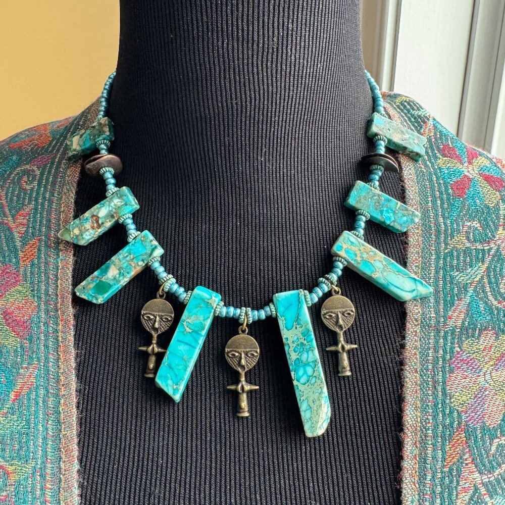 A unique & fun choker necklace. Sea sediment block beads & African brass dolls.